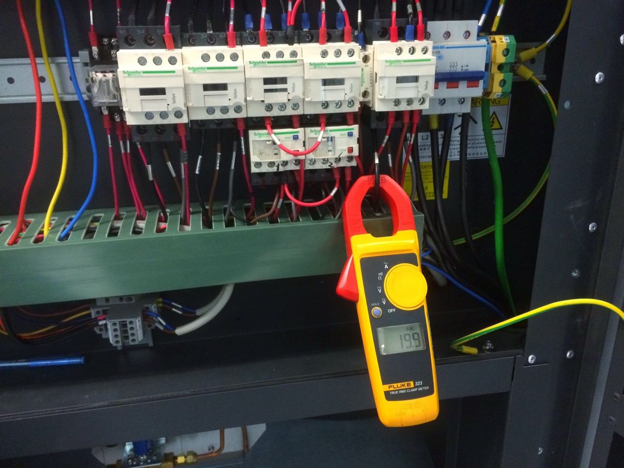 Digital FLUKE Amp Meter on black wire to measuring current on electrical system.