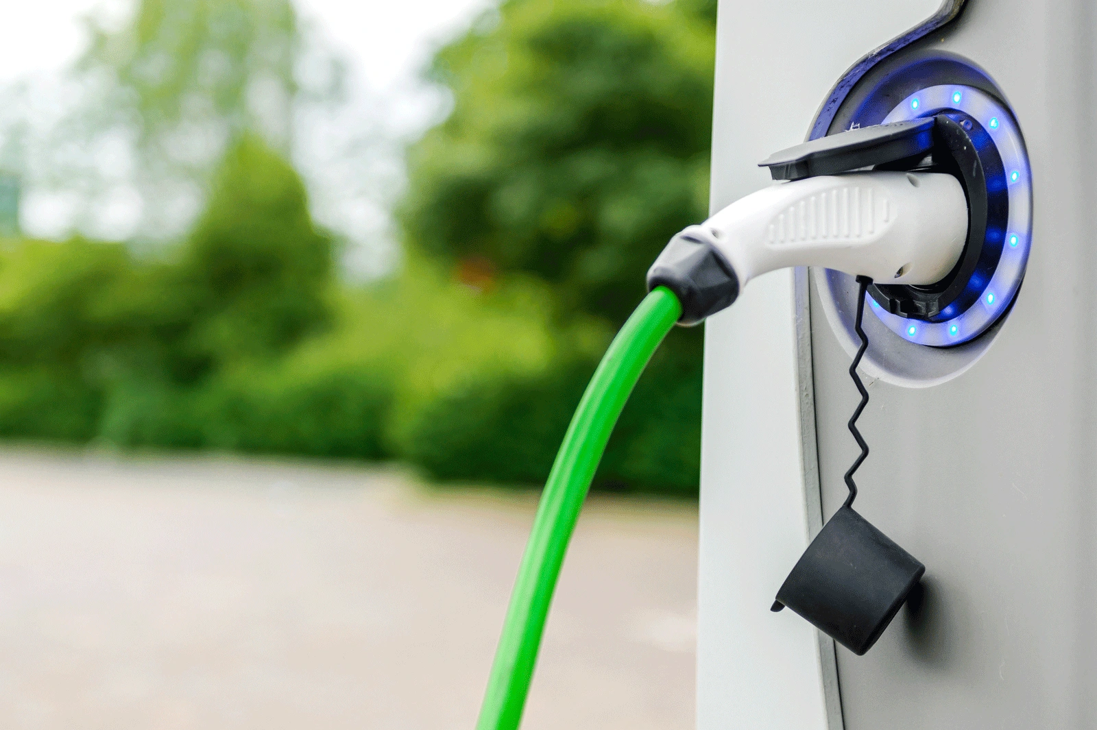 Green charging cable connected to an EV charger